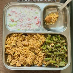 Enjoy this protein-packed soya pulav, a flavorful one-pot rice dish, served with cooling raita and sautéed green beans for a complete and wholesome meal.