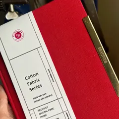 This red Colton Fabric notebook is paired with our 'Gratitude' clip. We believe that taking a moment to write down what you're thankful for can truly change your perspective. The paper inside is recycled natural fibre, soft to the touch.