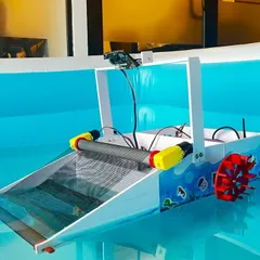 A close-up of the river cleaning robot, showing the conveyor belt mechanism and AI vision camera. We teach students how to integrate different components like sensors and motors to create complex, functional systems.