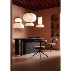 A retail space should also be a functional workspace for the brand. In this section of the showroom, we designed a client consultation area with a custom dark wood table and sculptural paper lanterns, blending business with beauty.