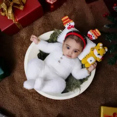 Another angle from our Christmas baby photoshoot. The overhead shot shows the baby nestled among presents, capturing the feeling of him being the greatest gift of all.