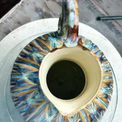 The colors on this pitcher make it one of my favorite pieces. The way the glazes melted and flowed in the kiln created these yummy flashes of blue, purple, and yellow. It’s pure kiln magic.