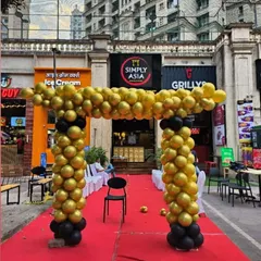 A grand opening needs a grand entrance. I created this classic black and gold balloon arch over a red carpet for the opening ceremony of Simply Asia, ensuring the new restaurant made a strong first impression.