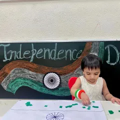 This young learner is focused on placing the green pieces on her flag collage. Celebrating national days through art helps instill a sense of patriotism from a young age.