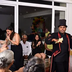 The look of pure astonishment is what I live for. Here, I am performing the classic dove production, a timeless piece of magic that delights audiences of all ages at corporate family days and celebrations.