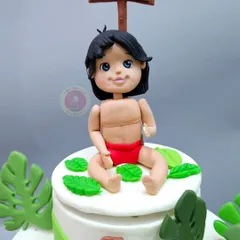 A close-up of the hand-sculpted Mowgli figurine. Capturing the innocent and adventurous spirit of the character was the most important part of bringing this Jungle Book theme to life.