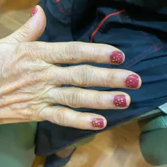 The beautiful result of our Ayurvedic manicure on a senior client, finished with our non-toxic, nourishing nail polish.