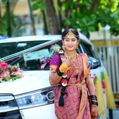Posing by the wedding car, this bride is ready for her big entrance. Her traditional gold jewelry is perfectly complemented by the makeup.