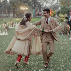 A candid, joyful moment from an intimate garden engagement, with the couple dancing freely, surrounded by candlelight.