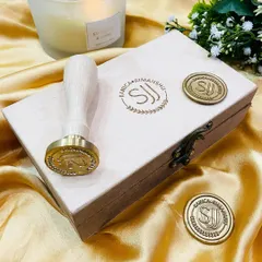 A close-up of the custom brass stamp and the beautiful wax seals it creates. We can design it with your initials, monogram, or logo.