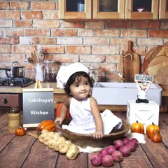 A fun and unique chef-themed sitter session. Dressed in a little chef's hat, this baby is the star of her own kitchen, complete with a brick wall backdrop and cooking props.