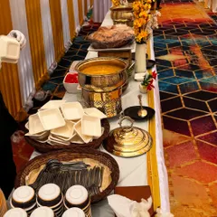 This buffet setup for the C.S.I.F unit at Andheri Airport features a vibrant and colorful theme. The patterned carpet is complemented by our elegant white and gold decor and floral arrangements.