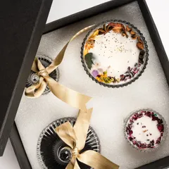 A top-down view of the 'Eternal Elegance: Classic Duo' gift box. The intricate details of the dried floral toppings are visible, showcasing the artistry involved.