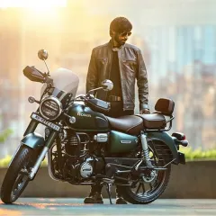 This image from the Honda CB 350 ad campaign features a model in a grey leather jacket. The styling is clean and modern, designed to complement the sleek green and chrome details of the bike.