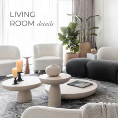 An overview of the living room details, showing how the curved white and black sofas, stone coffee tables, and a large fiddle-leaf fig plant come together. The space is a testament to how bold, geometric forms can still feel soft and inviting.