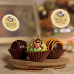 Showcasing our coconut rose truffle, this image captures the delicate texture and beautiful topping of rose petals. It's a unique flavor that combines floral notes with creamy chocolate.