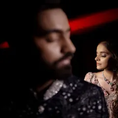 An artistic portrait with the groom out of focus in the foreground. This technique draws the eye to the bride and creates a sense of depth and story.