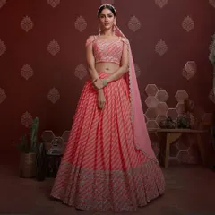 A gorgeous pink lehenga designed for twirling. The striped pattern on the skirt is complemented by a beautifully embroidered border and a modern off-shoulder blouse, making it ideal for a daytime wedding event.