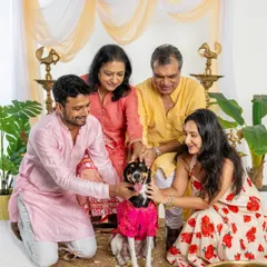A loving family surrounds their dog during a festive Diwali shoot. This photo captures the warmth and togetherness of celebrating with every member of the family.