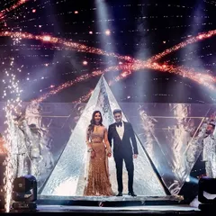 A powerful pose to mark the beginning of their performance. The couple stands on a custom-built pyramid stage, flanked by dancers and framed by pyrotechnics, ready to kick off their sangeet night.