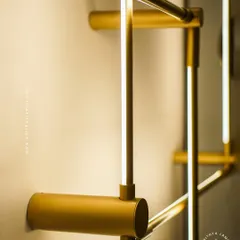 A closer look at our minimalist square LED wall sconces. The slim gold-finished frame emits a soft backlight, creating a halo effect on the wall. These can be arranged in overlapping patterns for a custom art installation.