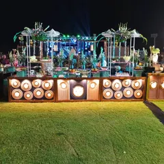 This is an example of my large-scale outdoor catering for a wedding, featuring an elaborate, multi-tiered salad bar that serves as a stunning centerpiece on the lawn.