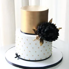 A bold and beautiful cake for a 50th birthday celebration. I paired a quilted white fondant tier with a metallic gold top tier, accented with a dramatic handmade black sugar flower.