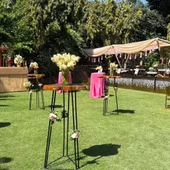 A view of the farmhouse lawn set up for a Holi party. We used a mix of low picnic seating and high cocktail tables to create a dynamic and comfortable space for guests to mingle.