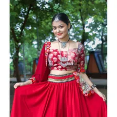 A lovely portrait of the model in a natural, park-like setting. Her smile and direct gaze create a welcoming and engaging image that highlights her traditional jewelry and outfit.
