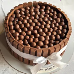 Indulge in decadence with every slice of this chocolate-loaded masterpiece, a truffle cake topped with Nutties and surrounded by KitKat bars.