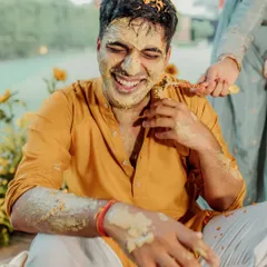 The groom's infectious laughter as he gets covered in turmeric by his loved ones. These are the candid, fun-filled moments that make for the best memories.