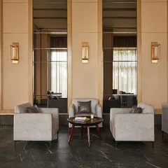 A seating area within the banquet hall, where mirrored wall panels and warm lighting create an intimate and elegant setting.