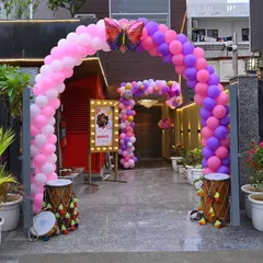 A beautiful balloon arch marks the entrance to this outdoor venue, setting a festive mood for the butterfly-themed party inside.