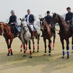 A team of our equestrians in formal attire, mounted and ready for an event, representing the discipline and professionalism of our academy.