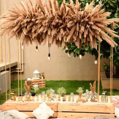 I love designing relaxed, boho-chic sundowners. This rooftop setup features a low sit-down arrangement with plush cushions, a custom pampas grass installation, and warm lighting to create the perfect, dreamy vibe as the sun sets.