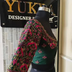 This view highlights how the embroidery extends seamlessly from the sleeve to the body of the blouse, creating a cohesive and luxurious design.