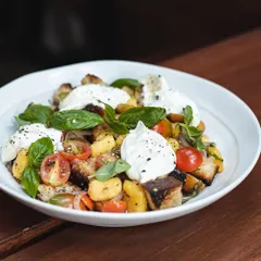 Our seasonal Mango Tuscan Salad is back. It's a refreshing mix of fresh mangoes, sourdough croutons, cherry tomatoes, and creamy burrata.