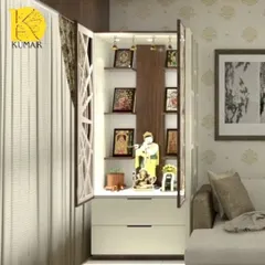 This compact, wall-mounted pooja cabinet is perfect for apartments. It features jali doors, internal lighting to highlight the idols, and a two-drawer storage unit below.