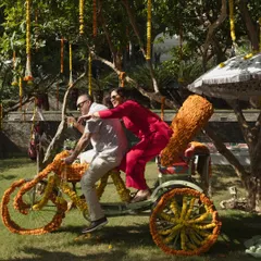 Guests having fun on a custom-decorated floral rickshaw at a daytime Mehendi. I incorporate playful and interactive elements like this to keep guests entertained.