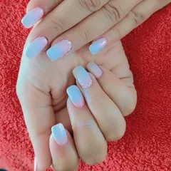 A dreamy ombre effect blending from a soft pink at the cuticle to a pastel blue at the tip on square-shaped nails.
