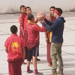 Correcting the grip and form for a shot. These interactions remind us that coaching is about connecting with people and sharing a passion, no matter where you are.