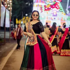A full-length portrait from a Garba night. Her multi-colored lehenga and cool sunglasses create a fun, festive, and modern-traditional look.