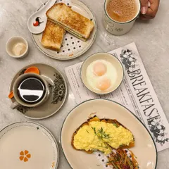 A beautiful breakfast spread from a cafe. This shot is styled to look like a real, enjoyable meal, creating an authentic and inviting image for the cafe's social media or menu.