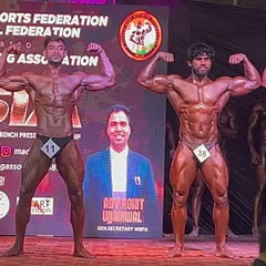 A front double biceps pose on the Mr. Asia stage. Notice the muscle separation and symmetry, key details we perfect during contest prep.