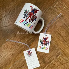 A perfect return gift for a superhero-themed birthday party. This set includes a personalized mug and matching luggage tags featuring a team of superheroes and the child's name in colorful letters.