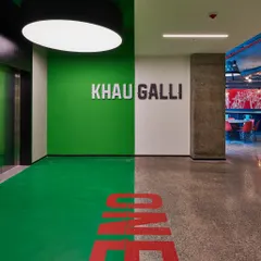 The entrance to the "Khau Galli" (Food Street) cafeteria. We used bold graphics and colors to create a distinct identity for this social space, making it a destination within the office.