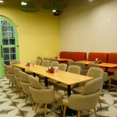 The clean and inviting dining area, ready to serve families. The long tables are great for larger groups or parties.