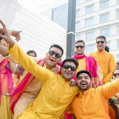 The groom's side having a blast at the Haldi. I helped coordinate the outfits for our friends and family, choosing various shades of yellow and orange to create a festive, unified look.