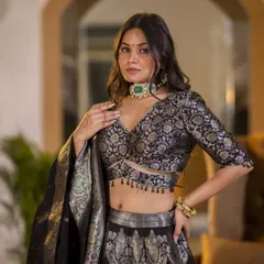 A closer shot of the Banarasi lehenga, focusing on the detailed blouse and the model's jewelry. This helps highlight how the outfit can be styled for a wedding or special occasion.