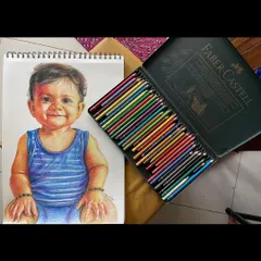 Here you can see a finished baby portrait alongside the tools of my trade. The rich pigments of the Polychromos pencils allow for deep layering to achieve that soft, lifelike skin tone. It’s a delicate process that brings so much joy.